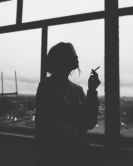 silhouette of woman smoking cigarette
